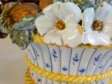 a blue and white vase with white flowers in it