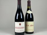 two bottles of wine sitting next to each other on a table