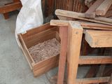 a pile of wood sitting on the ground next to a pile of wood