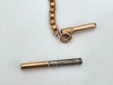 a gold chain with a lighter and a lighter in it