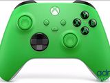 a close up of a green xbox controller on a white background
