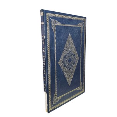 an old book with a blue cover and gold trimming