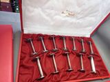 a red box with six silver spoons in it