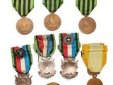 several medals and medals are displayed in a row on a white surface