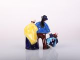 a figurine of two people sitting on a bench