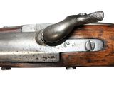 a close up of a gun with a wooden handle on a white background