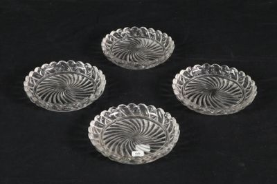 four clear glass bowls sitting on top of a black surface