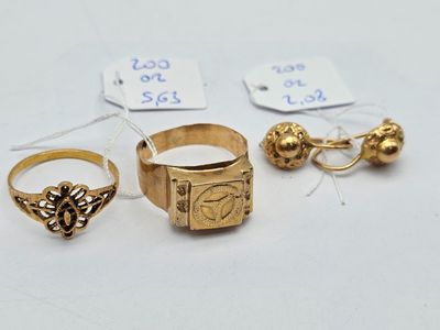 three gold rings and a ring with a heart on it