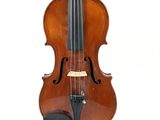 an old violin sitting on a white surface with a white background