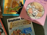 several children ' s books are lined up on a table