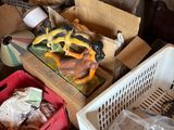 several boxes of assorted items sit on the floor in a cluttered room