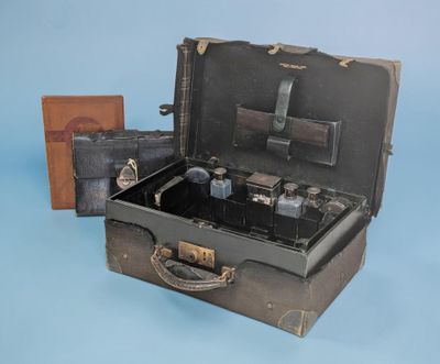 an old suitcase with a bunch of items inside of it