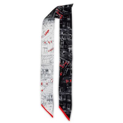 a black and white neck tie with a red design on it