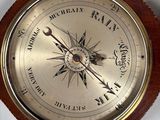 a wooden and brass compass on a white surface