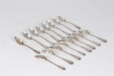 a set of six silver spoons on a white surface