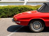 an image of a red car parked in a parking lot