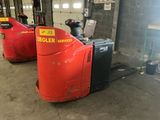 two red and black forklifts in a warehouse