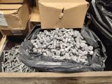 a box full of nuts and screws sitting on the floor