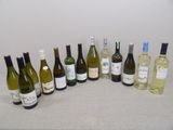 bottles of wine are lined up on a table in a row