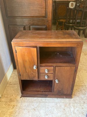 a wooden cabinet with two drawers and a door