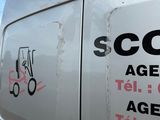 a white van that has some stickers on the side of it