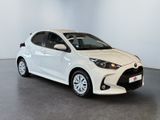a white toyota yaris parked in a white room