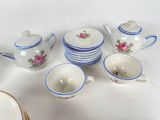 a lot of cups and saucers sitting on a table