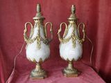 pair of antique white and gold vases on a red cloth