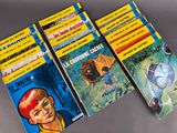 four children ' s books are lined up on a table