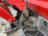 a close up of the front end of a red tractor