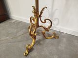 a gold table with a marble top and a gold base