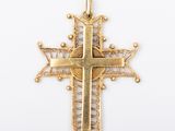 un pendentif en forme de croix dorée antique sur fond blanc