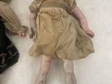 two dolls laying next to each other on the floor