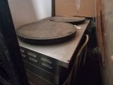 a pizza pan sitting on top of a stove in a kitchen