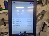 a computer screen that is on a stand in a room