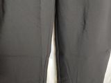 a close up of a pair of black pants on a hanger
