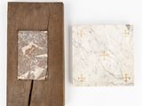 two pieces of marble on a wooden frame and a piece of wood on a white surface