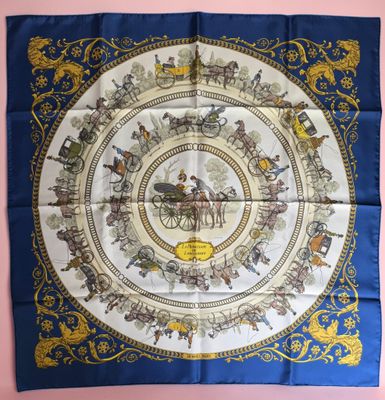 a blue and gold square scarf with a picture of a horse drawn carriage