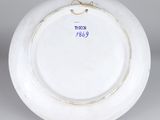 a white plate with a blue and white design on it