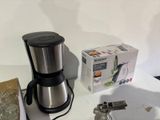 a coffee maker that is sitting next to a box