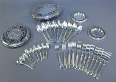 a lot of silver spoons and spoons on the table