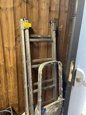 a ladder leaning against a wall next to a toilet