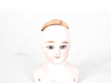 a small white busturine with a brown headband on it