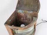 an old metal box with a wire in it on a white surface