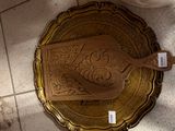 a gold plate with a wooden spoon on top of it