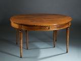 an oval dining table with two legs and a wooden top