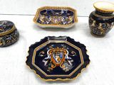 three pieces of pottery sitting on a white table