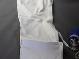 a pair of white pants laying on a bed