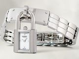 a silver bracelet with a padlock on it that is attached to a watch
