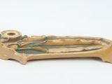 a small ceramic object that is on a white surface